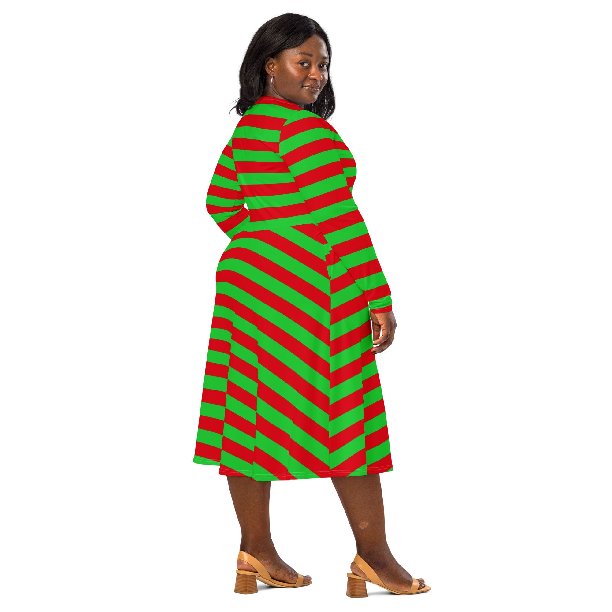 A plus-size woman wears a vibrant red and green long sleeve midi dress with chevron stripes and a belted waist
