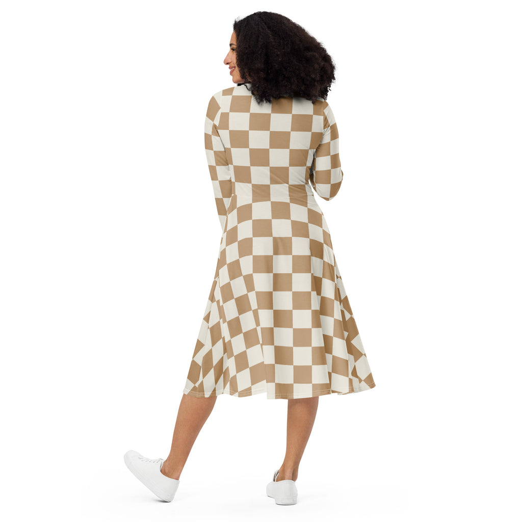 A woman wearing a women’s tan checkerboard long sleeve midi dress with pockets in beige and white colors