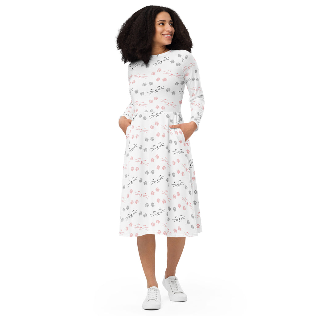 White midi dress with long sleeves featuring pink gray and black cat faces and paw prints with pockets