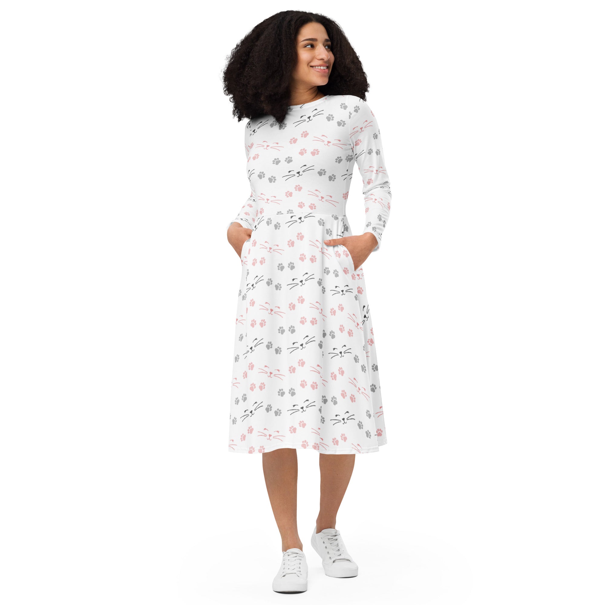 White midi dress with long sleeves featuring pink gray and black cat faces and paw prints with pockets