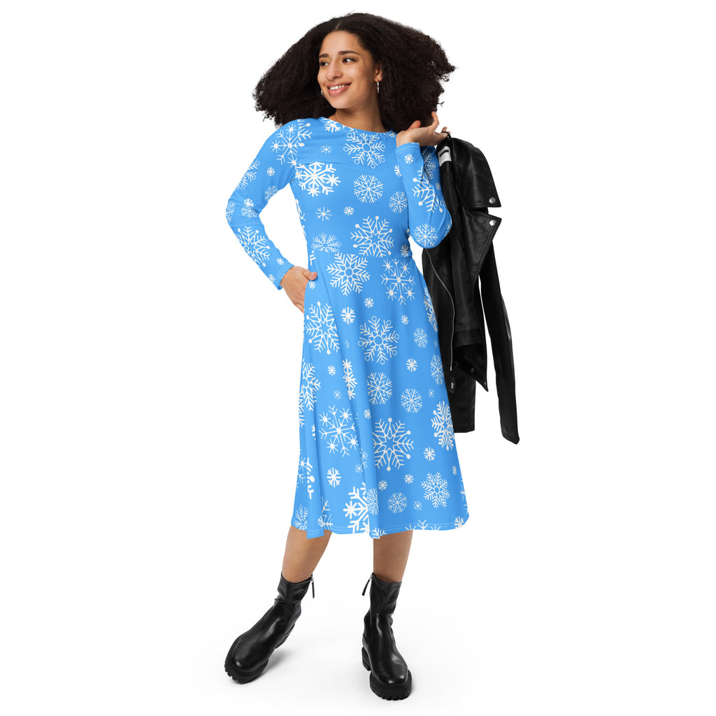 Women’s blue long sleeve midi dress with white snowflake pattern and pockets featuring a flattering fit