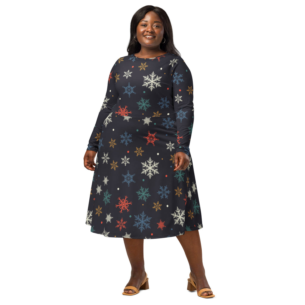 A plus-size woman wears a dark navy long sleeve a-line midi dress with colorful snowflake patterns and pockets