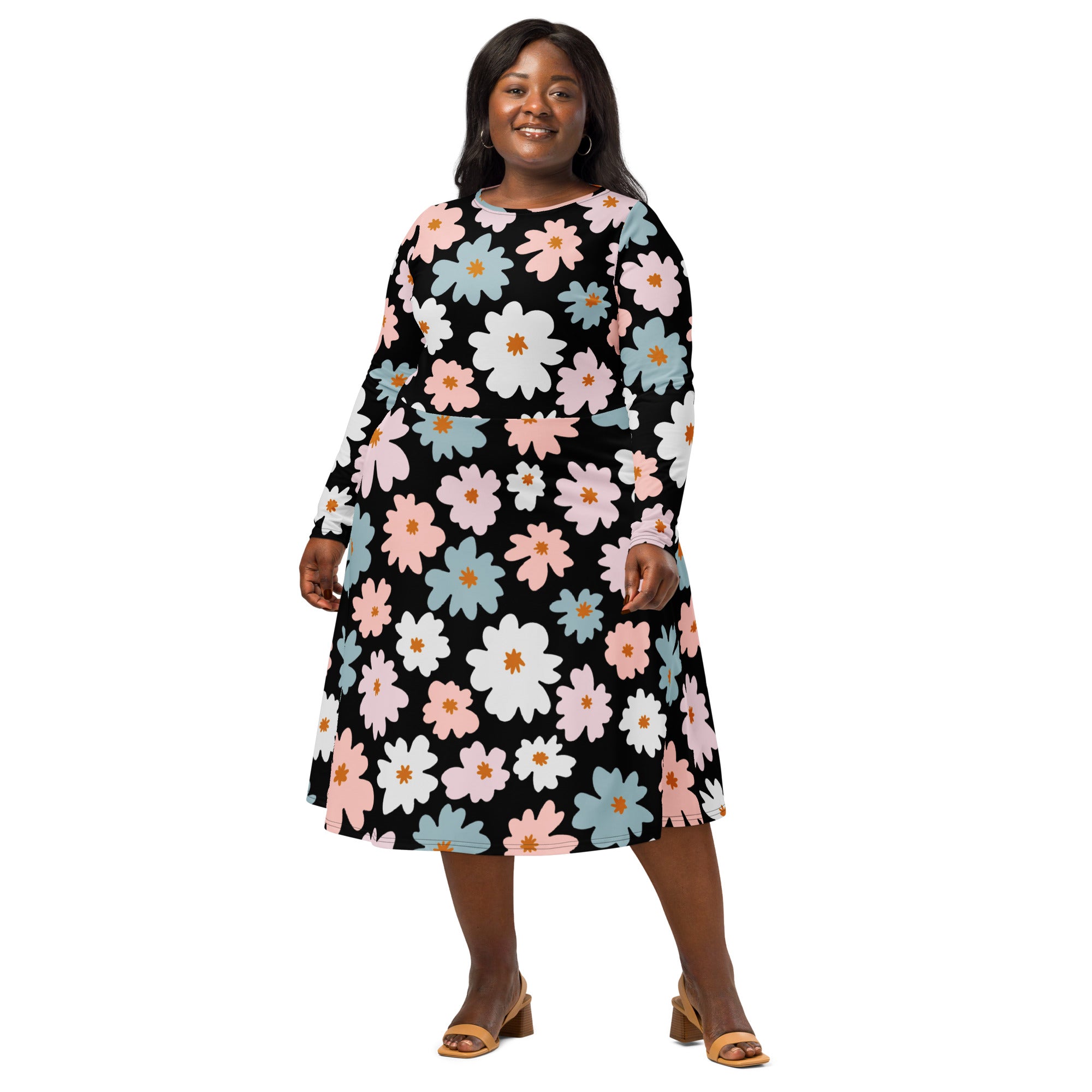 A plus-size woman wears a black retro floral long sleeve midi dress with pink white and light blue flowers and pockets