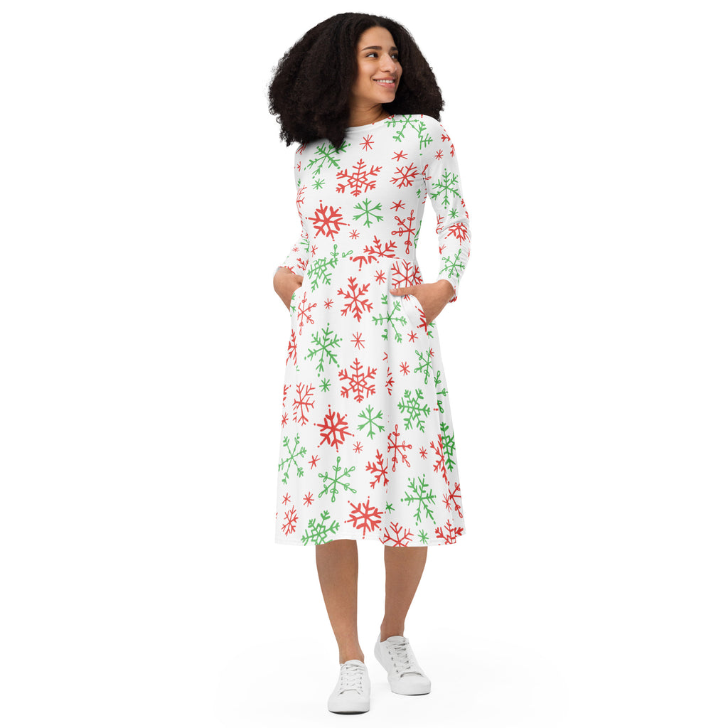 A festive white midi dress with red and green snowflake pattern long sleeves and side pockets for Christmas wear