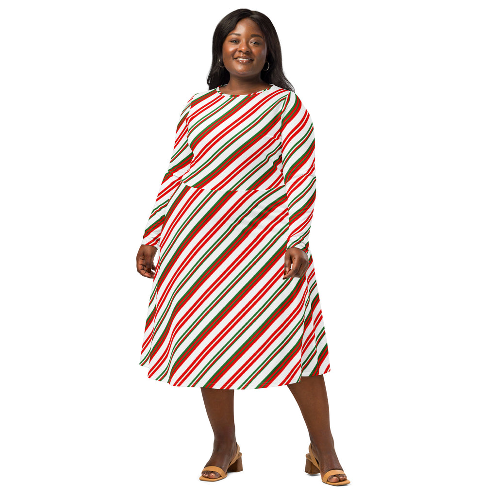 A plus-size woman wears a festive candy cane stripe long sleeve midi dress with pockets in red green and white
