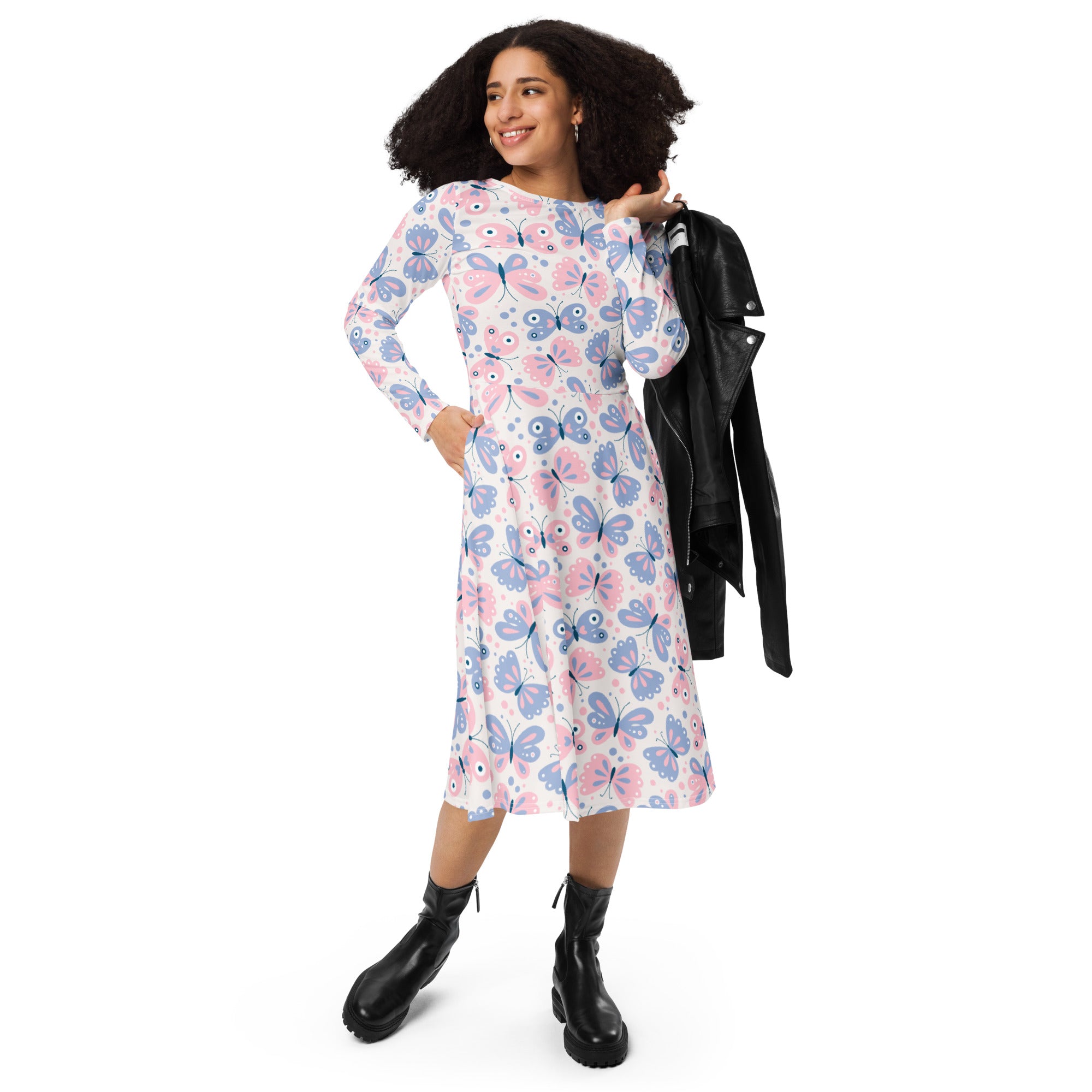 A woman wearing a women’s pink and purple butterflies long sleeve midi dress with pockets and playful cartoon print