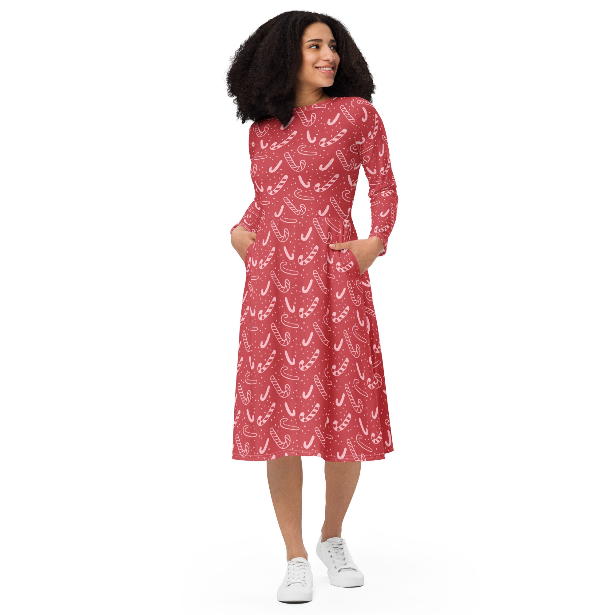 Women’s red candy cane midi dress with long sleeves and side pockets featuring a playful white pattern