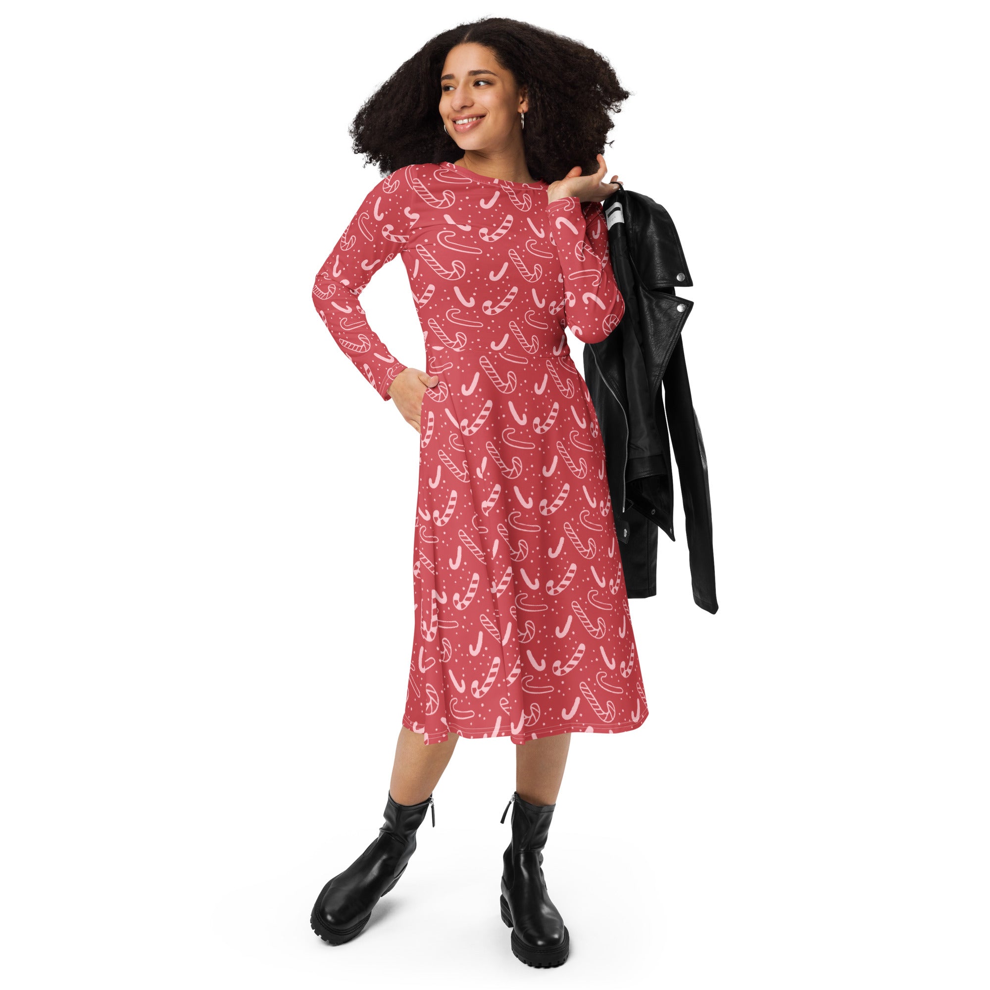 A festive red long sleeve midi dress with a playful candy cane pattern and pockets perfect for Christmas