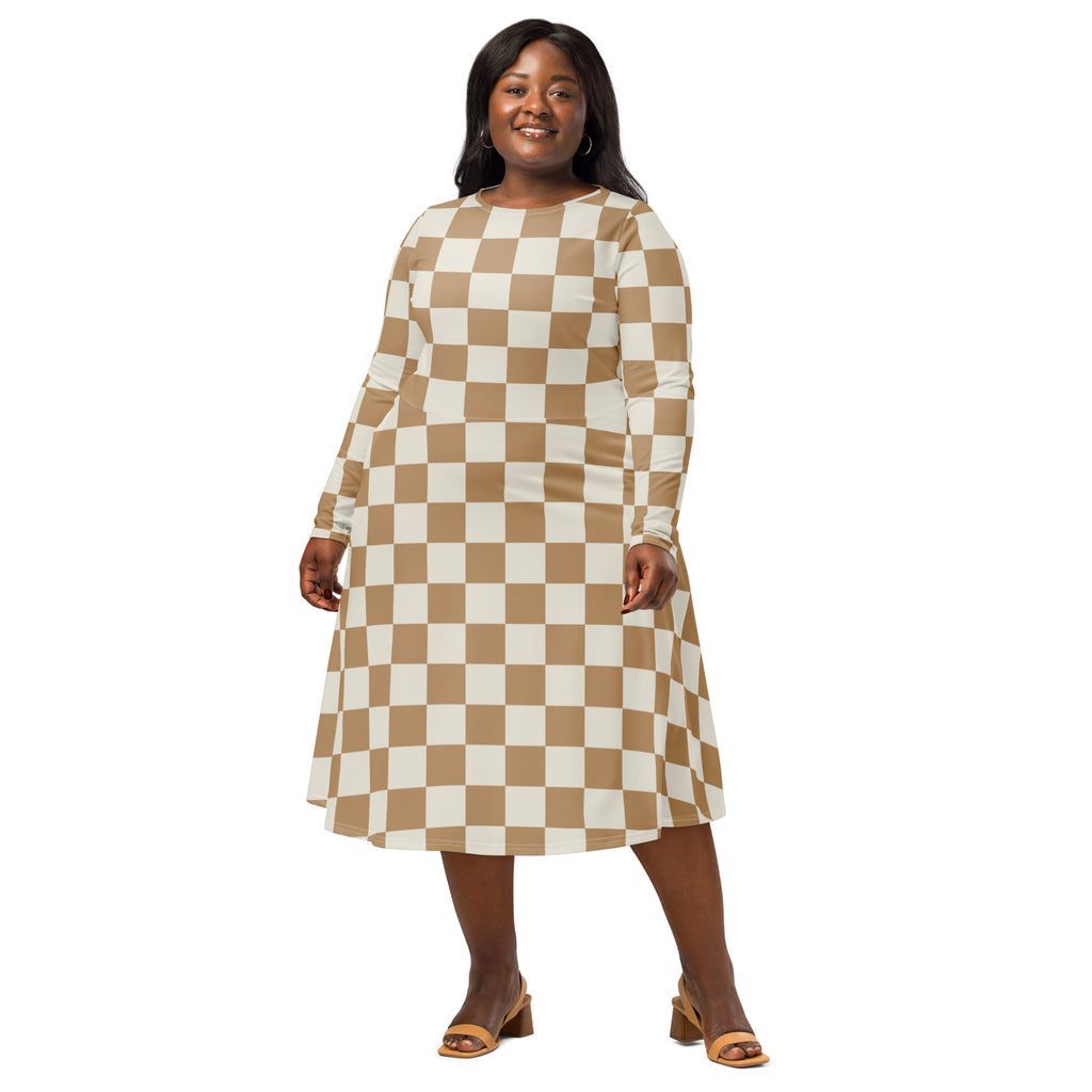 A plus-size woman wears a tan and cream checkerboard long sleeve midi dress with pockets and an a-line silhouette
