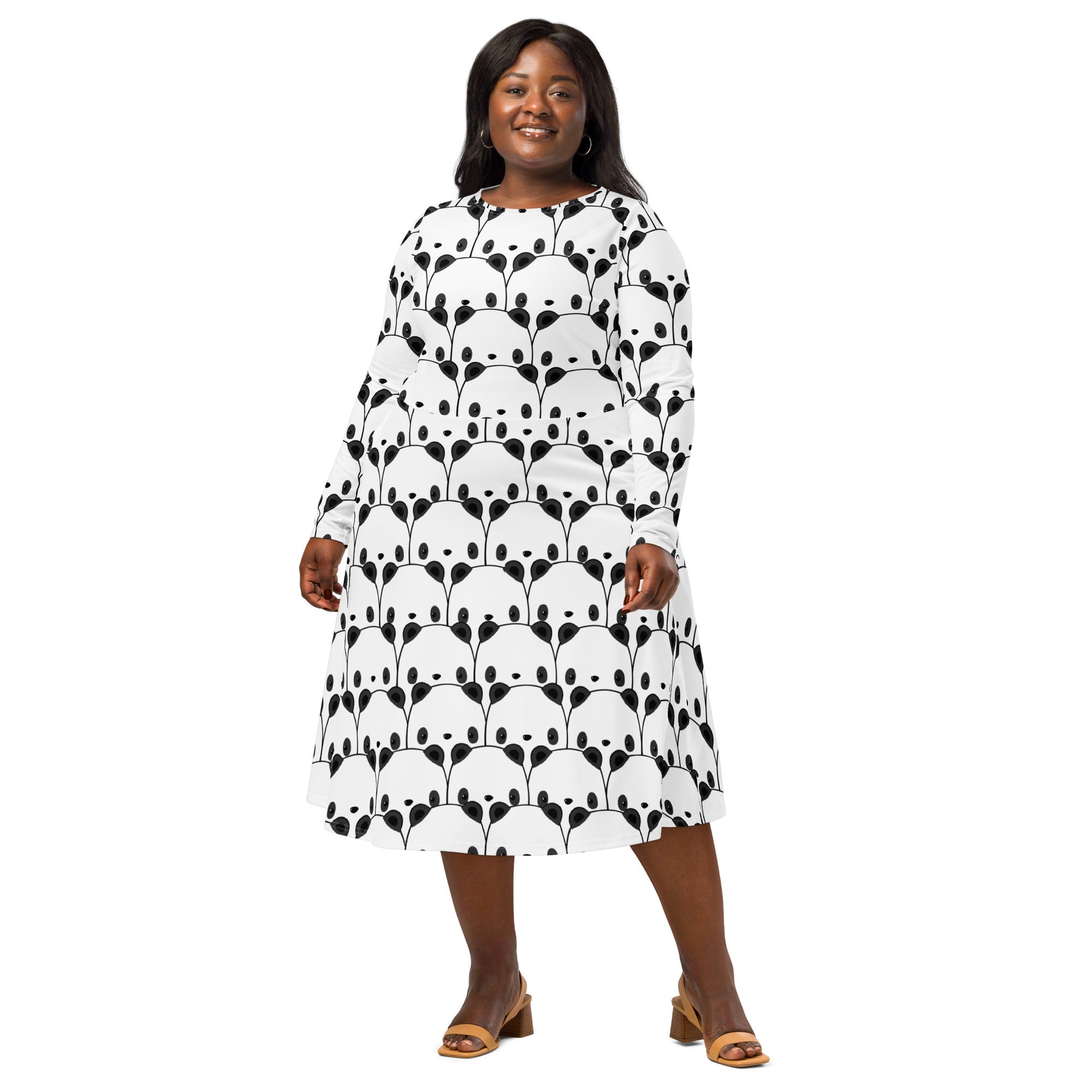 A plus-size woman wears a white long sleeve midi dress with pockets and black panda face pattern in an a-line silhouette