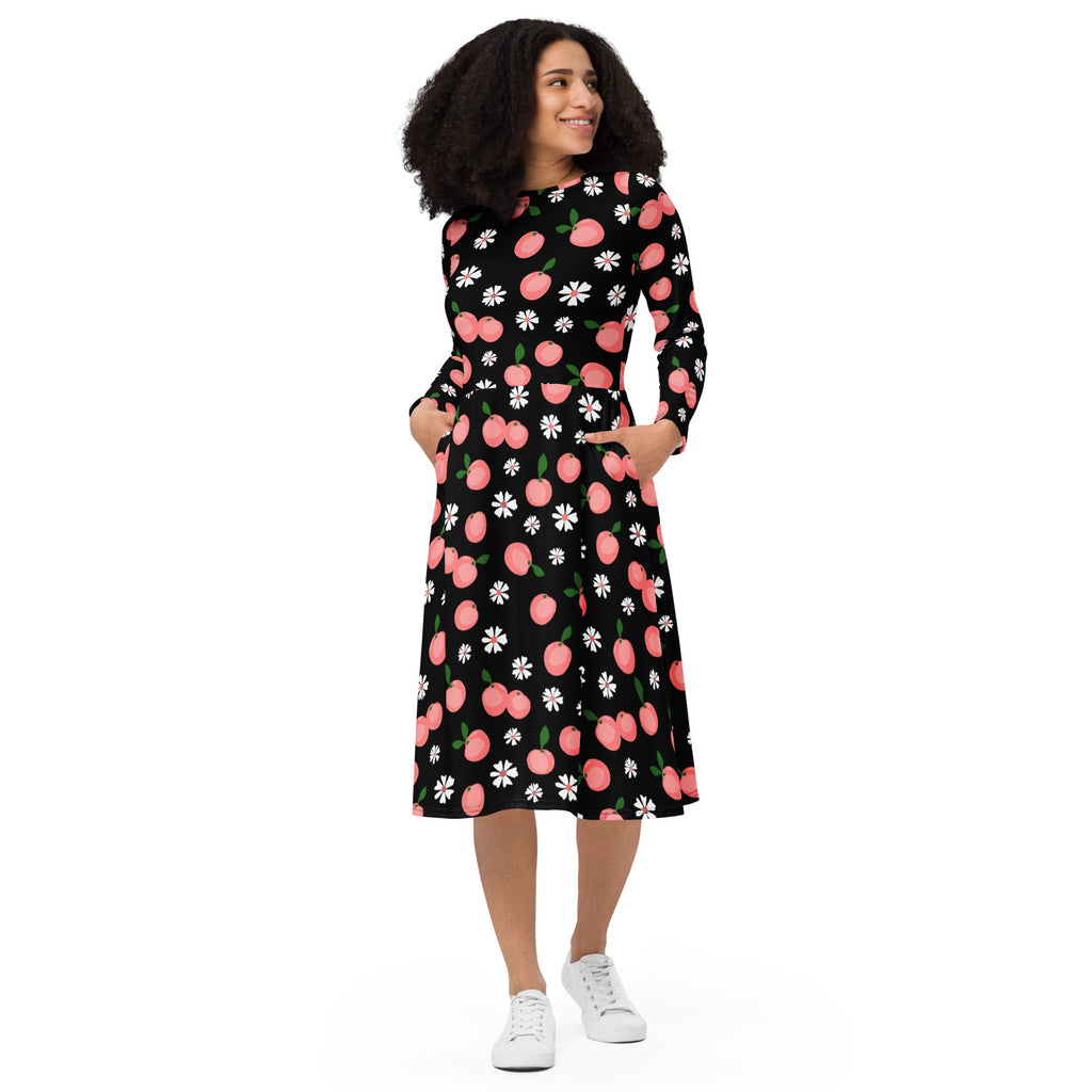 A black long-sleeved midi dress with pink peaches white daisies featuring pockets for women