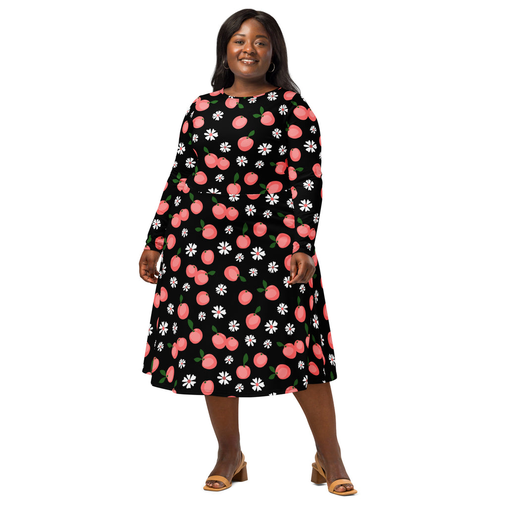 A black plus-size women’s long sleeve midi dress with pink cherry and white daisy pattern and pockets