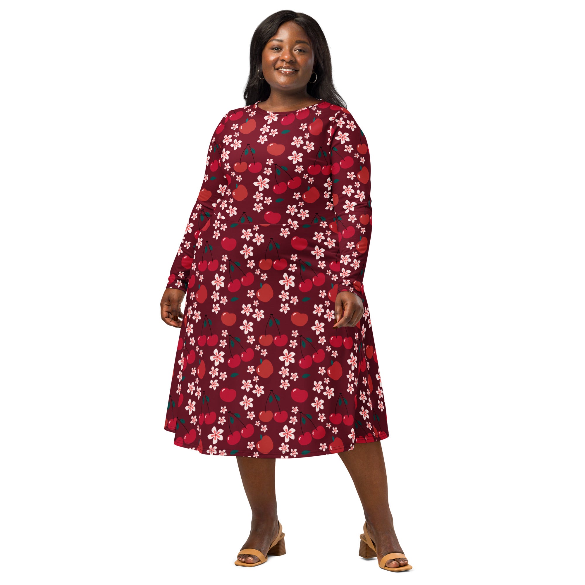 A plus-size woman wears a maroon cherry blossom long sleeve midi dress with pockets and an a-line silhouette