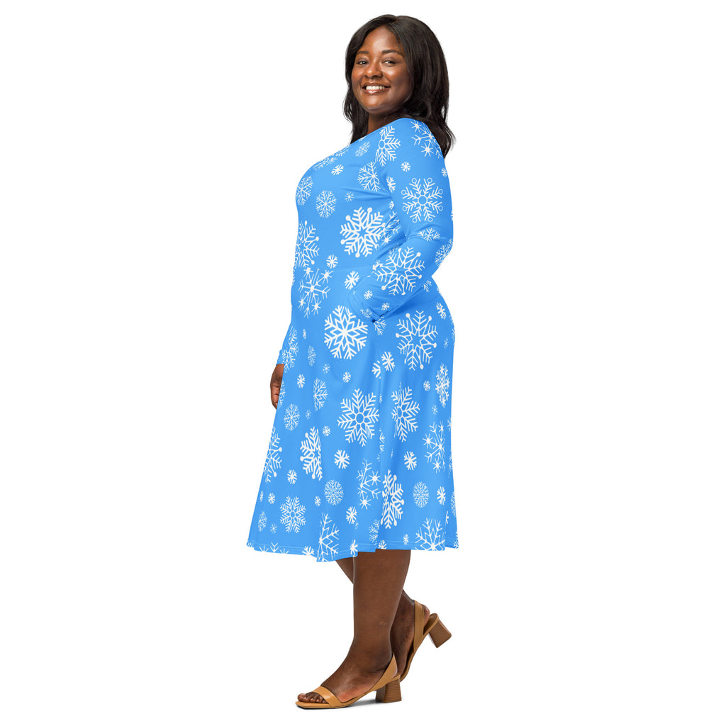 A vibrant blue long sleeve midi dress with white snowflake pattern and pockets perfect for winter wear