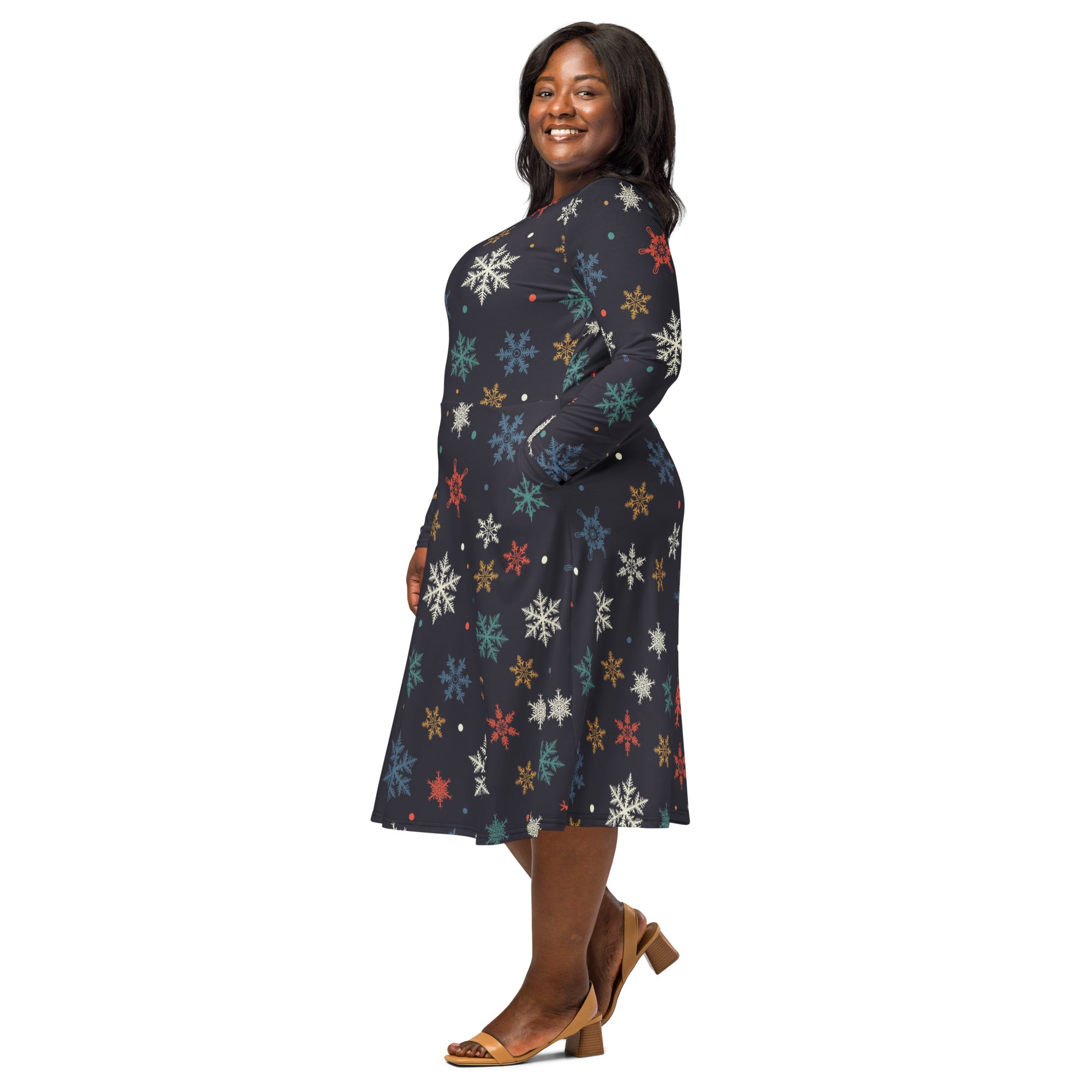 A plus-size woman wears a dark navy women’s colorful snowflake long sleeve midi dress with pockets