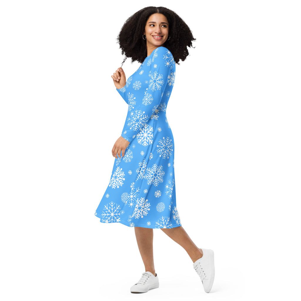 Women’s blue long sleeve midi wrap dress with white snowflake pattern and pockets featuring a flattering fit