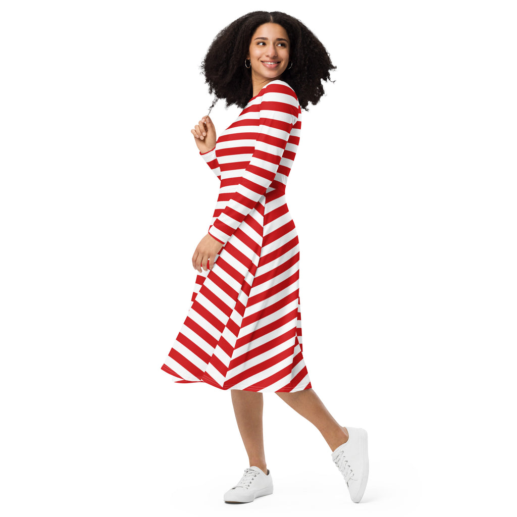 A woman wearing a red and white striped long sleeve midi dress with pockets and a flattering fit