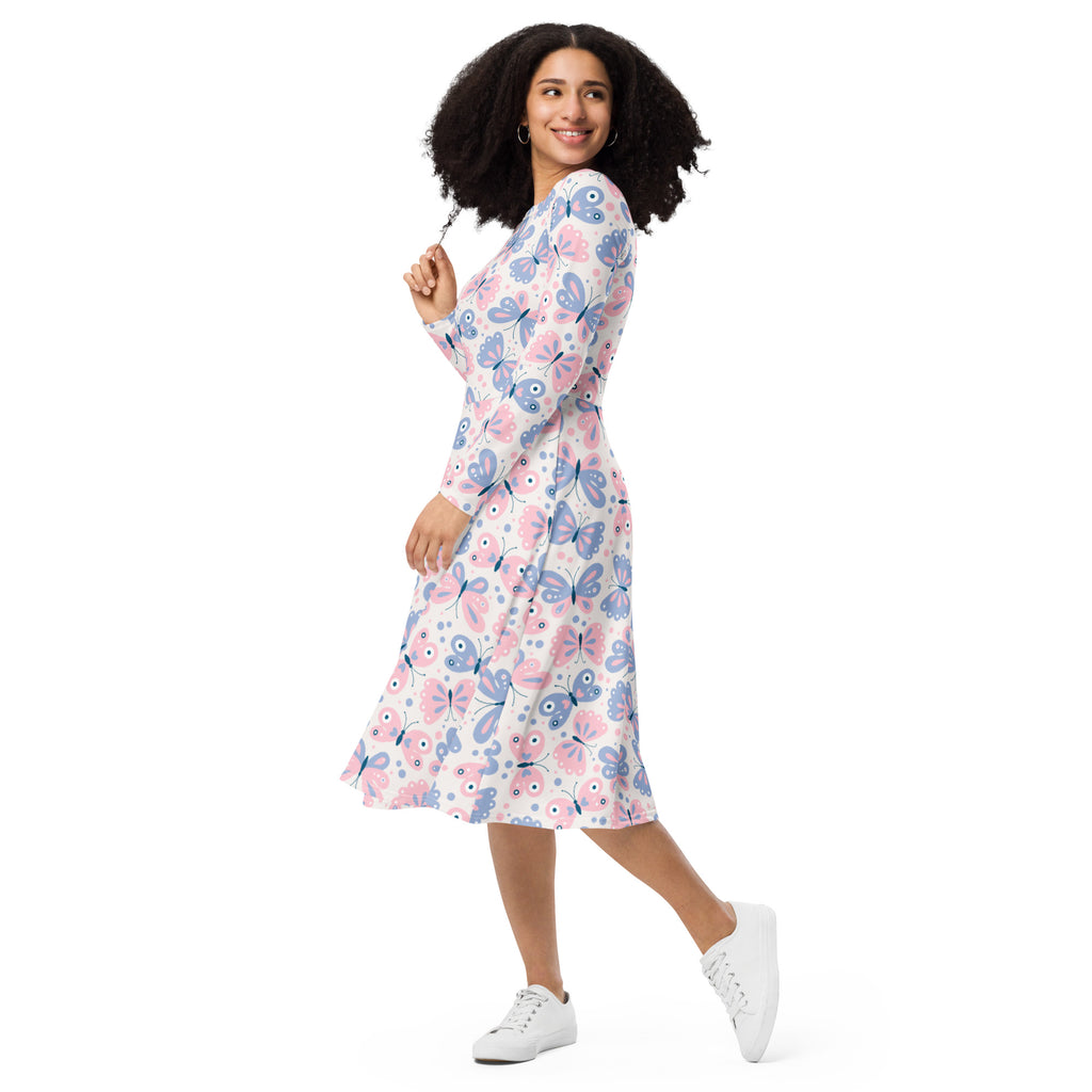 A woman wearing a women’s pink and purple butterflies long sleeve midi dress with pockets in soft hues on white background