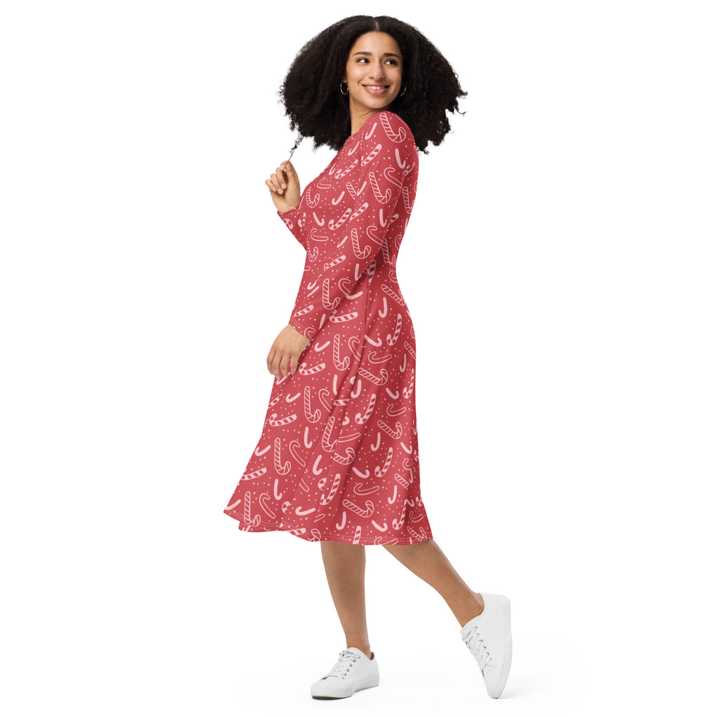 Women’s red midi dress with white candy cane pattern long sleeves and pockets perfect for christmas events