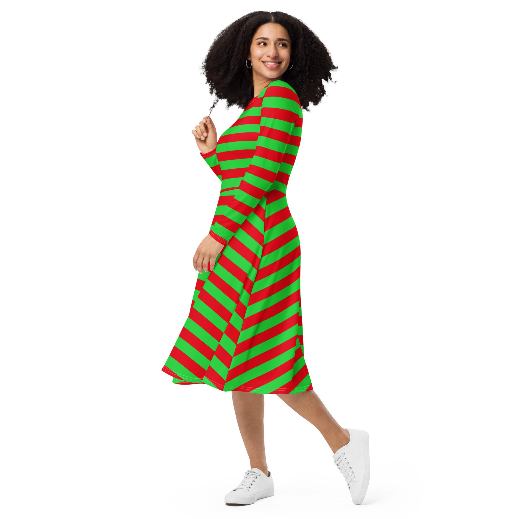 A woman wearing a women’s red and green long sleeve midi dress with pockets featuring diagonal stripes