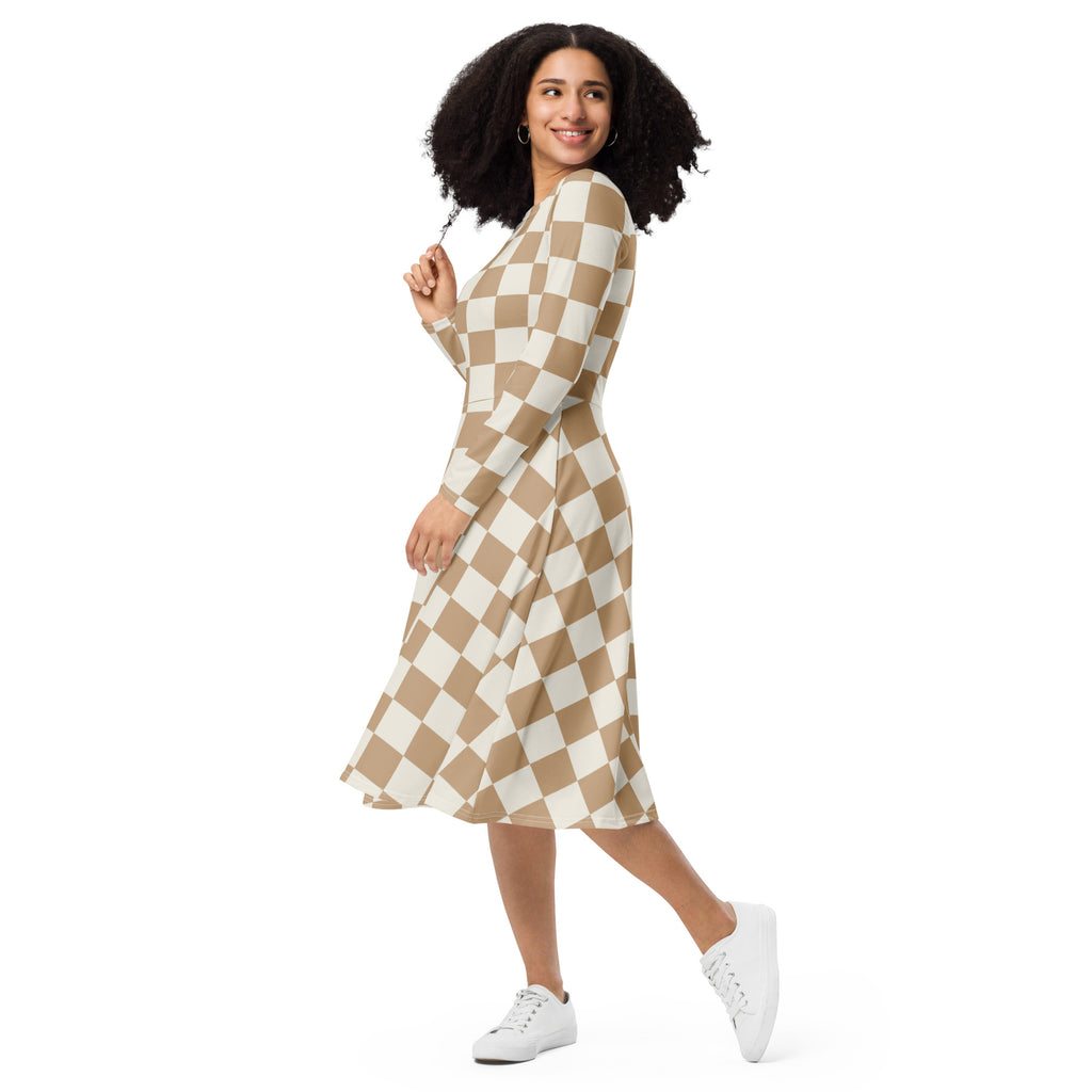 A woman wearing a women’s tan checkerboard long sleeve midi dress with pockets in beige and white