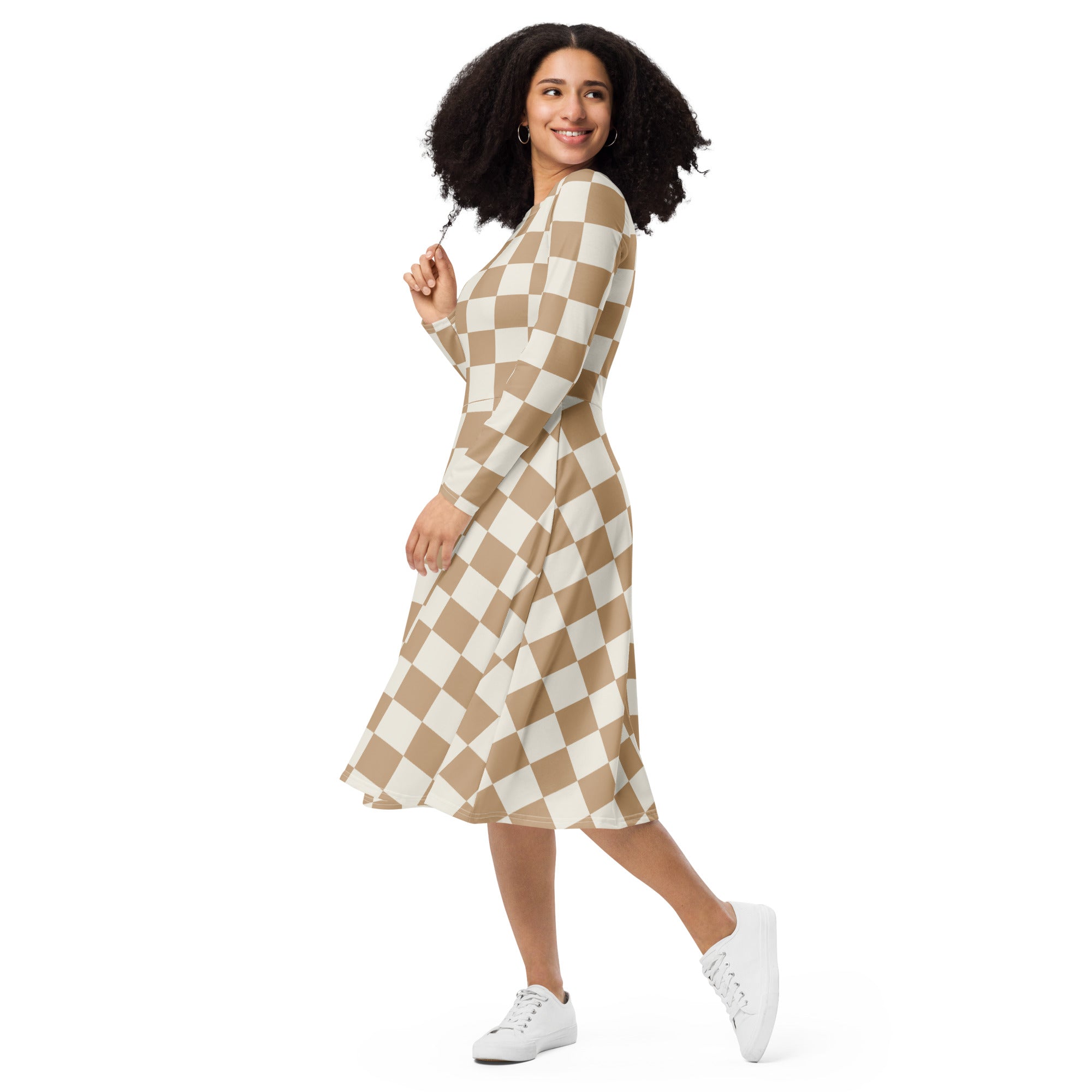 A woman wearing a women’s tan checkerboard long sleeve midi dress with pockets in beige and white