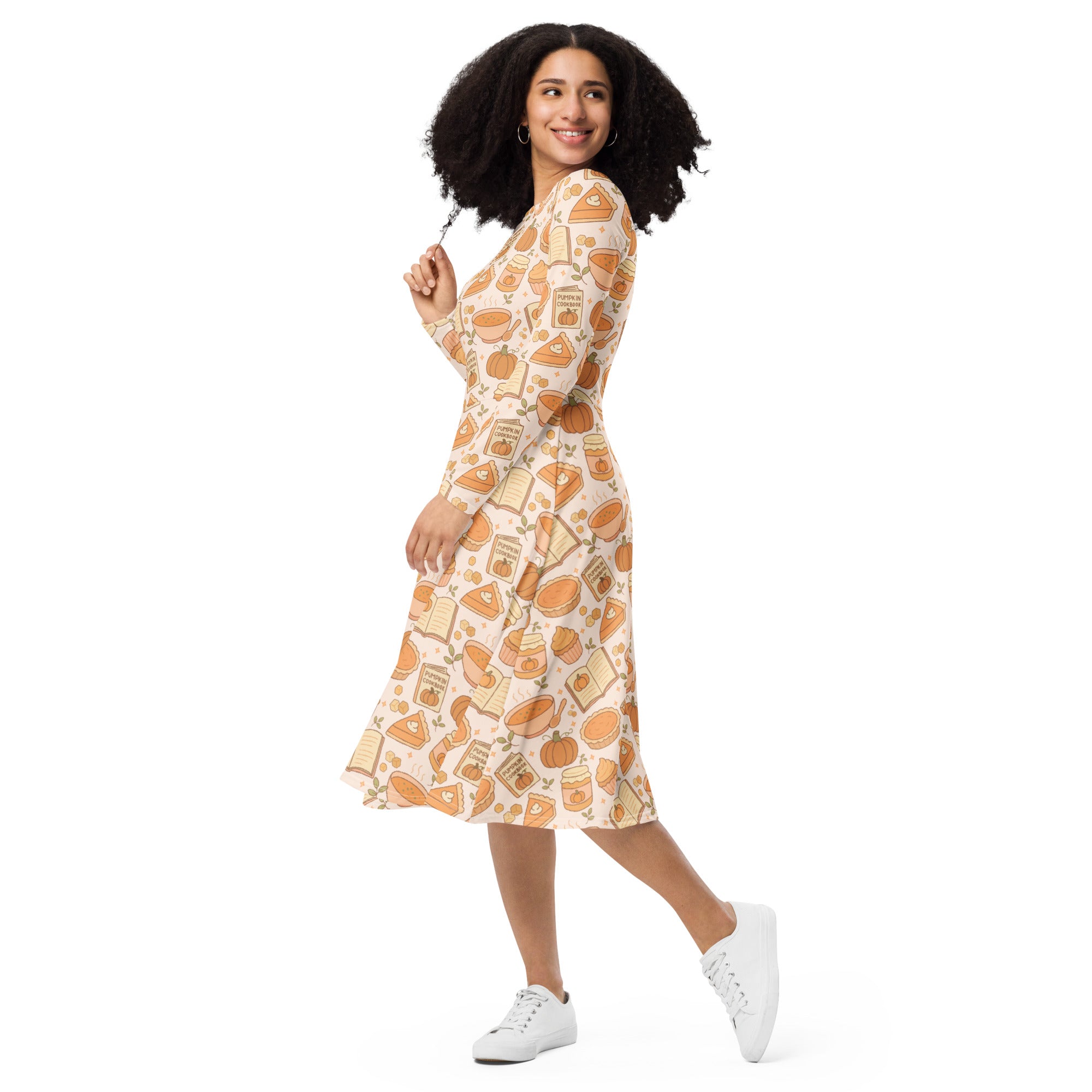 Women’s long sleeve midi dress in soft cream with orange pumpkin and pie slice print featuring autumn labels and pockets