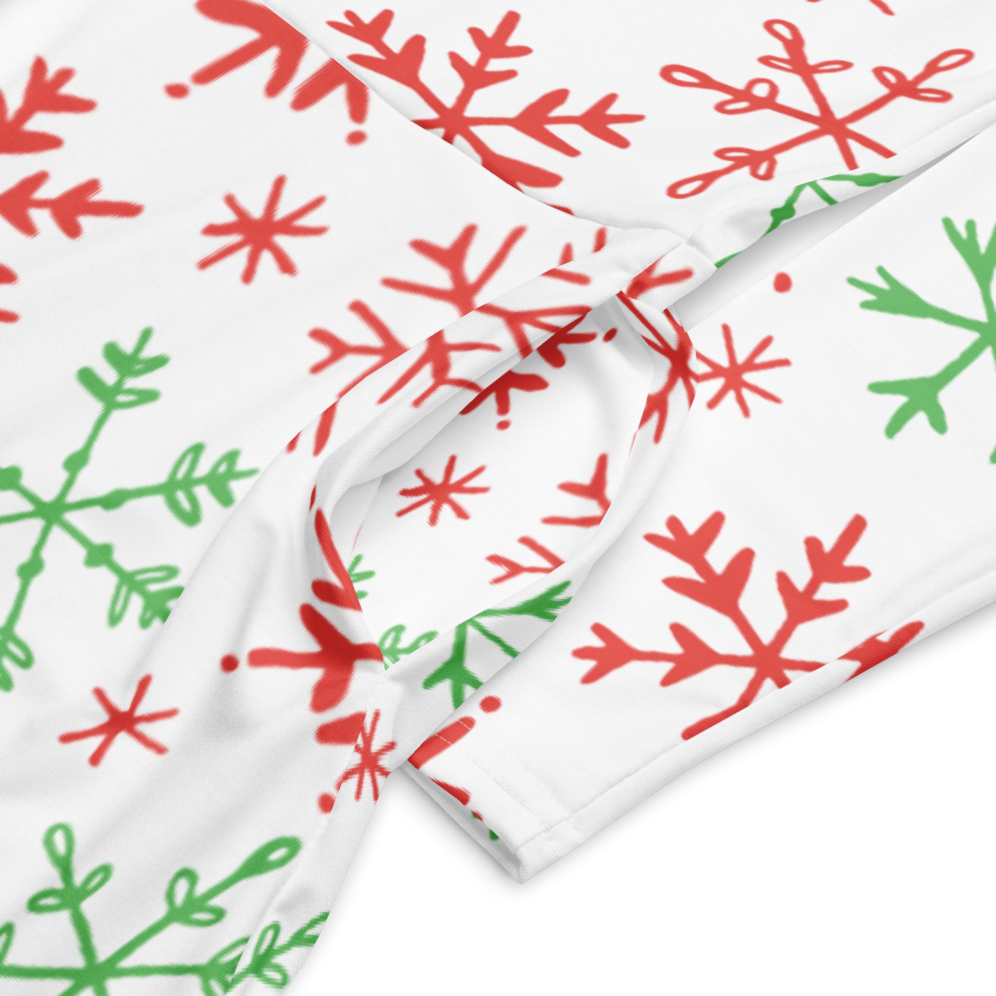 White fabric with playful red and green hand-drawn snowflakes on women’s red and green snowflake christmas long sleeve midi dress with pockets