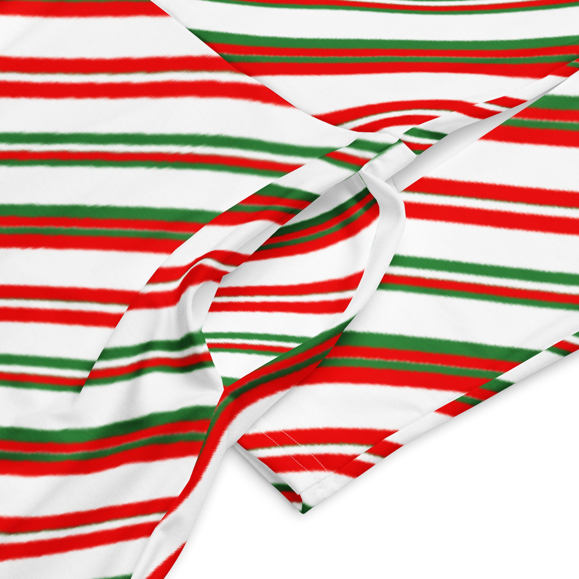 A soft fabric scarf with bold red and green stripes paired with a women’s candy cane stripe long sleeve midi dress with pockets