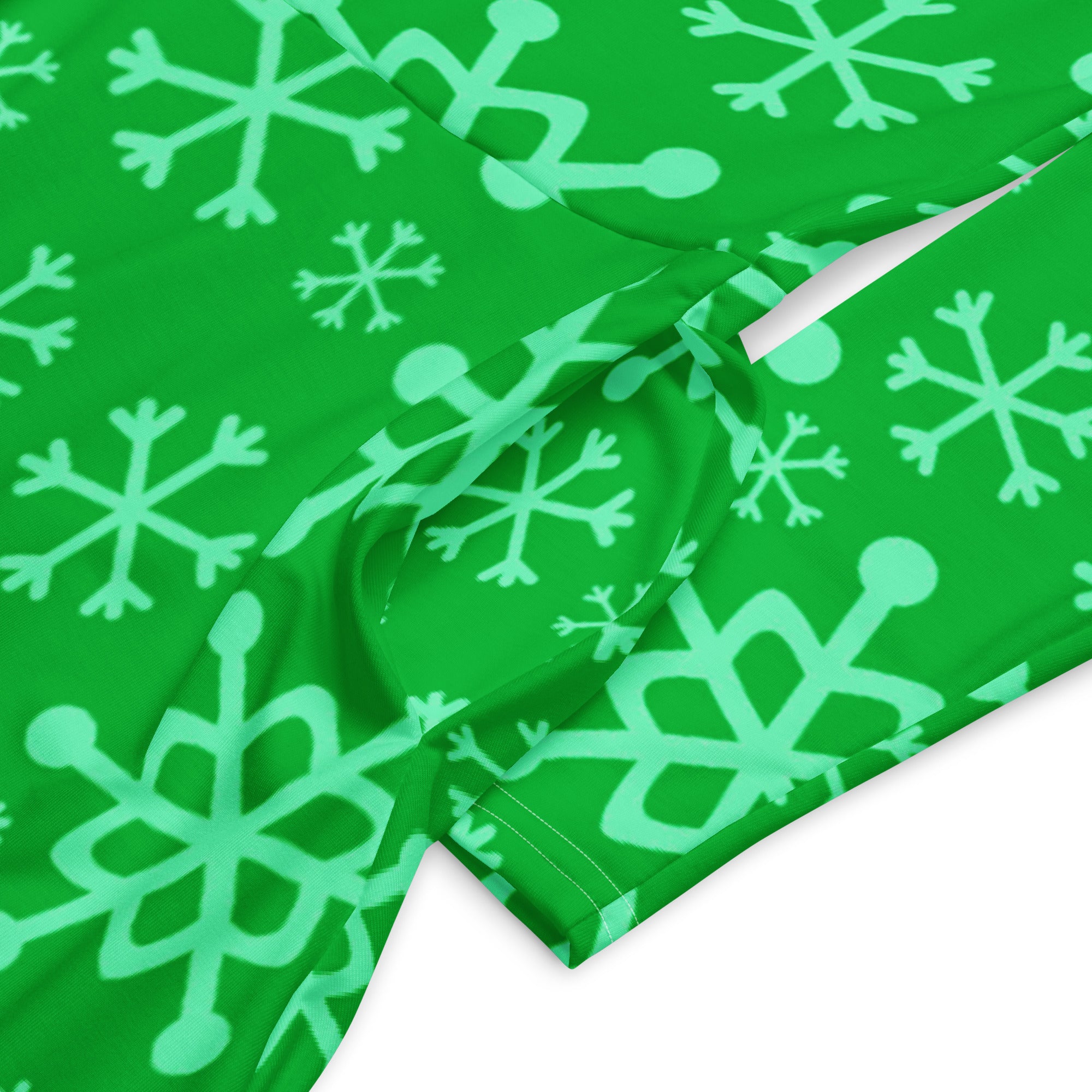 Women’s green long sleeve midi dress with pockets featuring a light green snowflake pattern on green fabric
