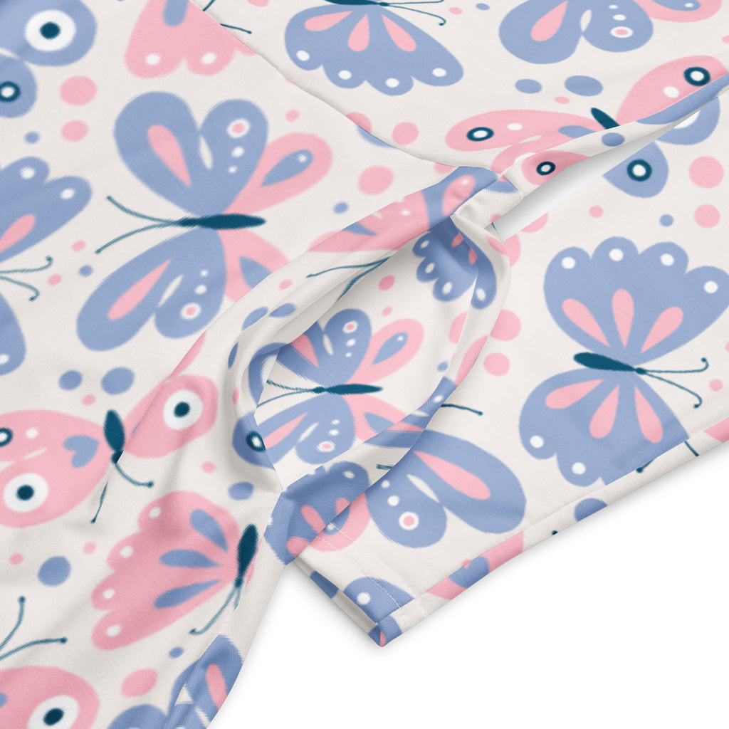 Women’s long sleeve midi dress with pockets in cream fabric featuring pink and purple cartoon butterflies pattern