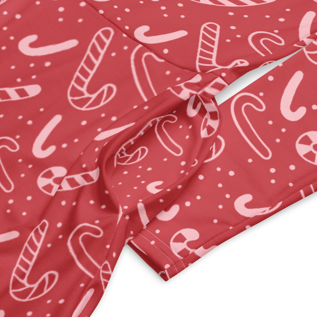 Women’s red long sleeve midi dress with pockets featuring festive white candy cane pattern on fabric