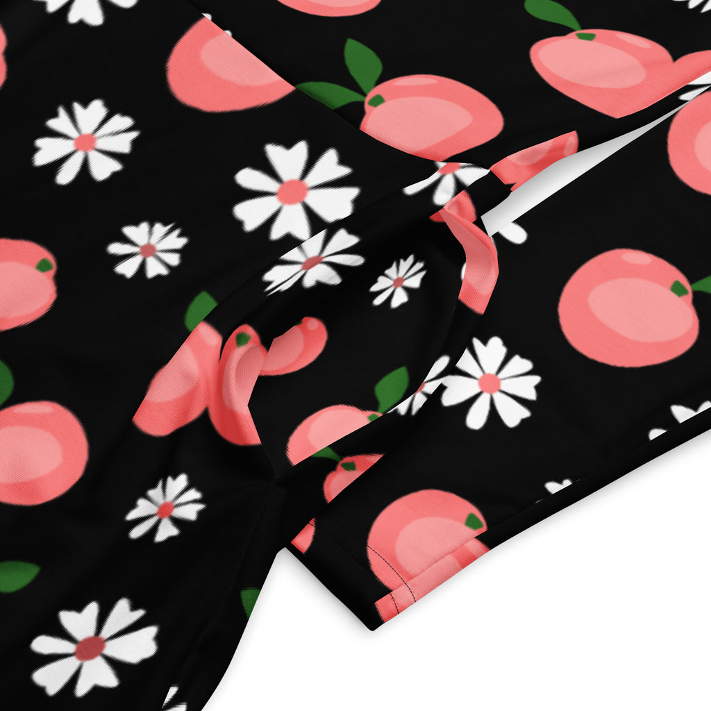 Women’s peach blossom long sleeve midi dress with pockets in black fabric featuring pink peaches and white daisies pattern