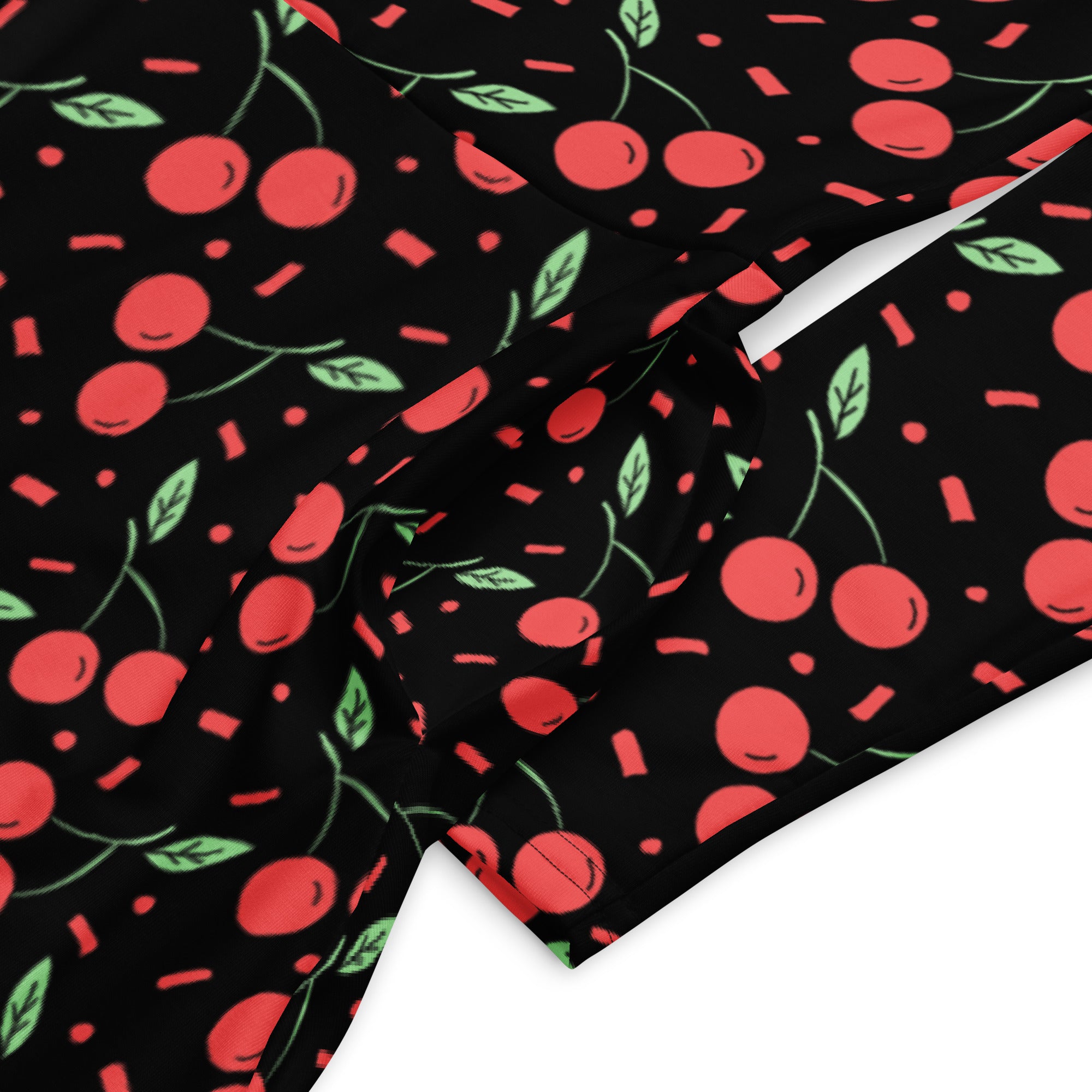 Women’s vintage cherry long sleeve midi dress with pockets in black fabric featuring red cherries green leaves and pink confetti