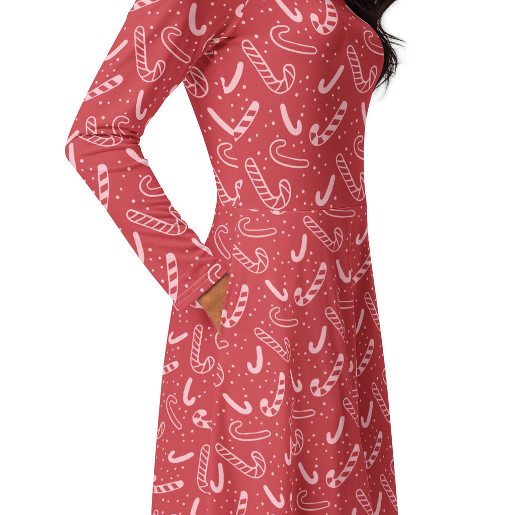 Women’s red long sleeve midi dress with pockets featuring a festive white candy cane pattern and tiny polka dots