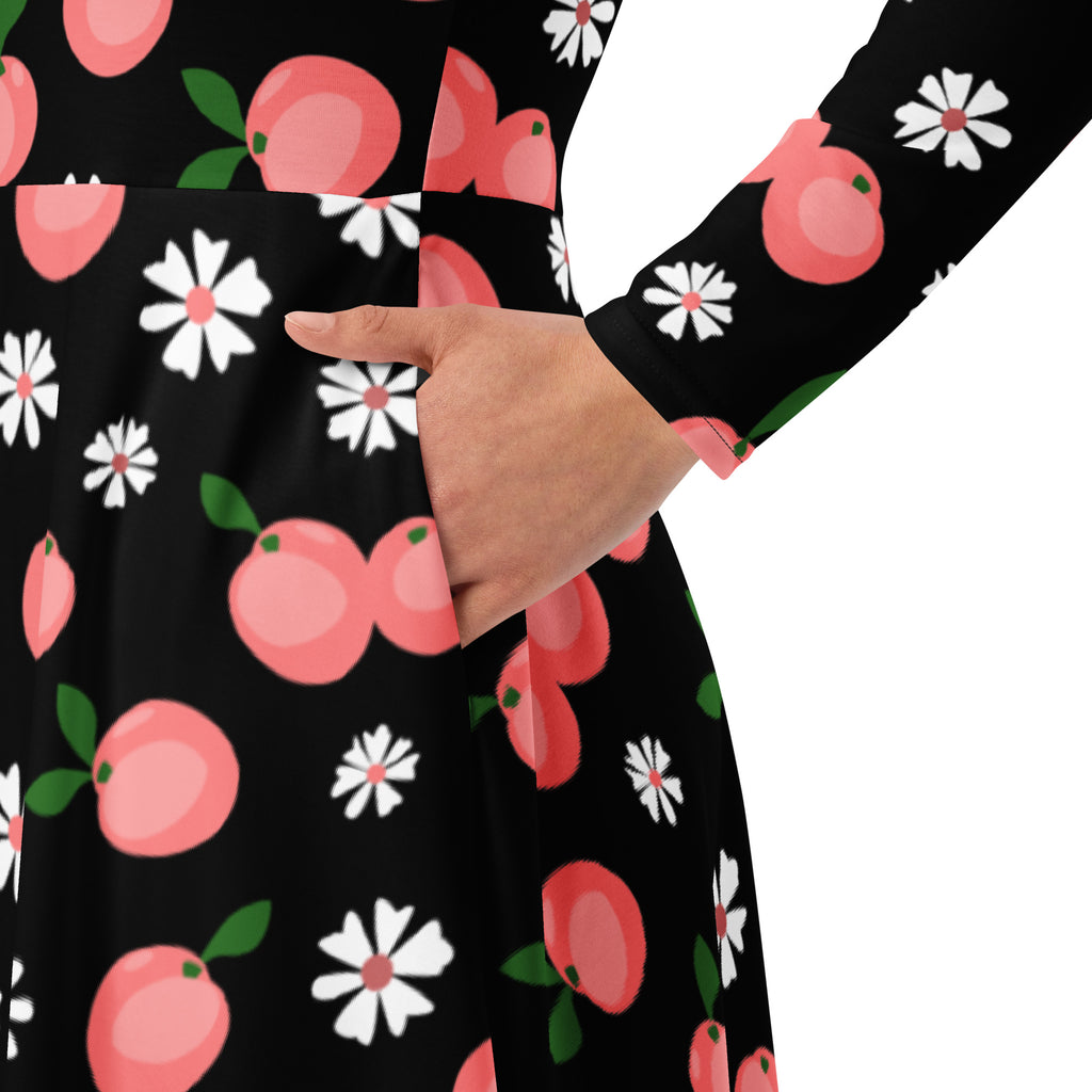 Women’s black long sleeve midi dress with playful pink peach and white daisy pattern and pockets