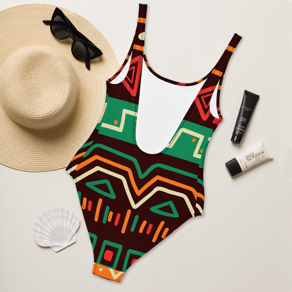 Women’s african-inspired tribal print one-piece swimsuit in brown green orange and red on stretchy buttery soft fabric with upf 50+