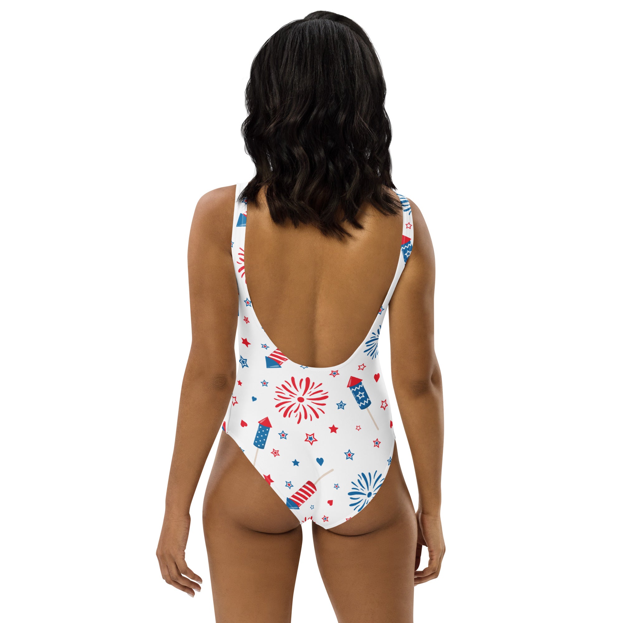 White one-piece buttery soft swimsuit with red white and blue fireworks stars and rockets pattern featuring UPF 50+ protection
