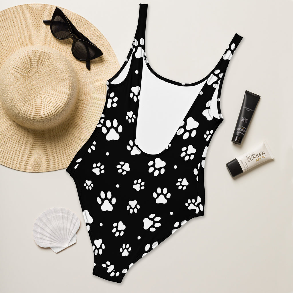 Women’s black one-piece swimsuit with white paw print pattern buttery soft fabric and UPF 50+ protection
