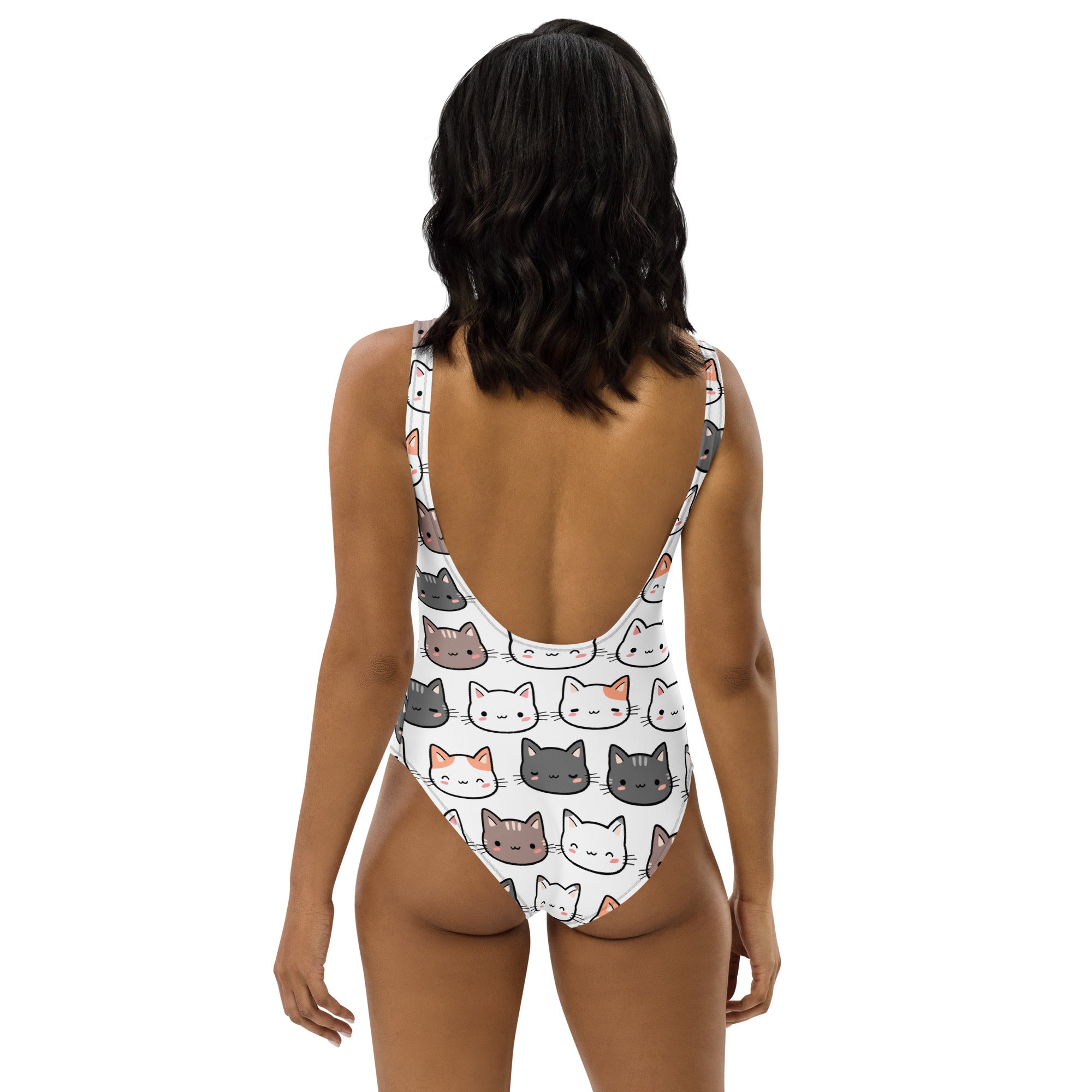 White one-piece buttery soft swimsuit with upf 50 plus featuring colorful cartoon cat faces pattern
