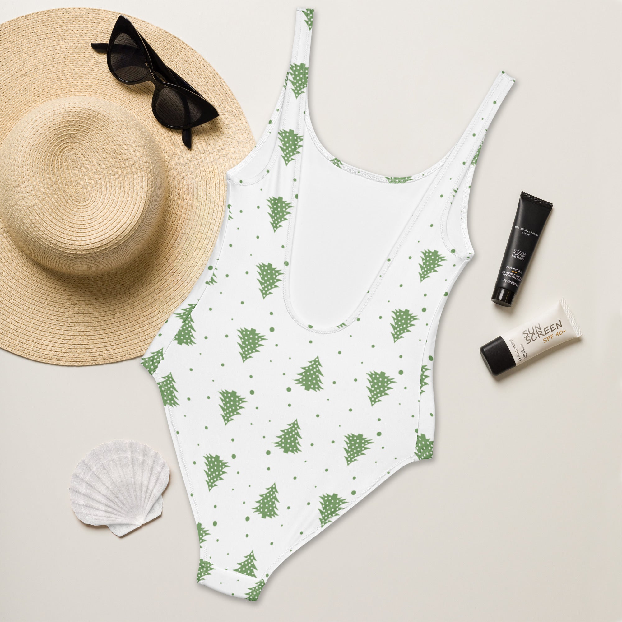 White one-piece minimalist swimsuit with green pine tree pattern buttery soft fabric and UPF 50 plus protection