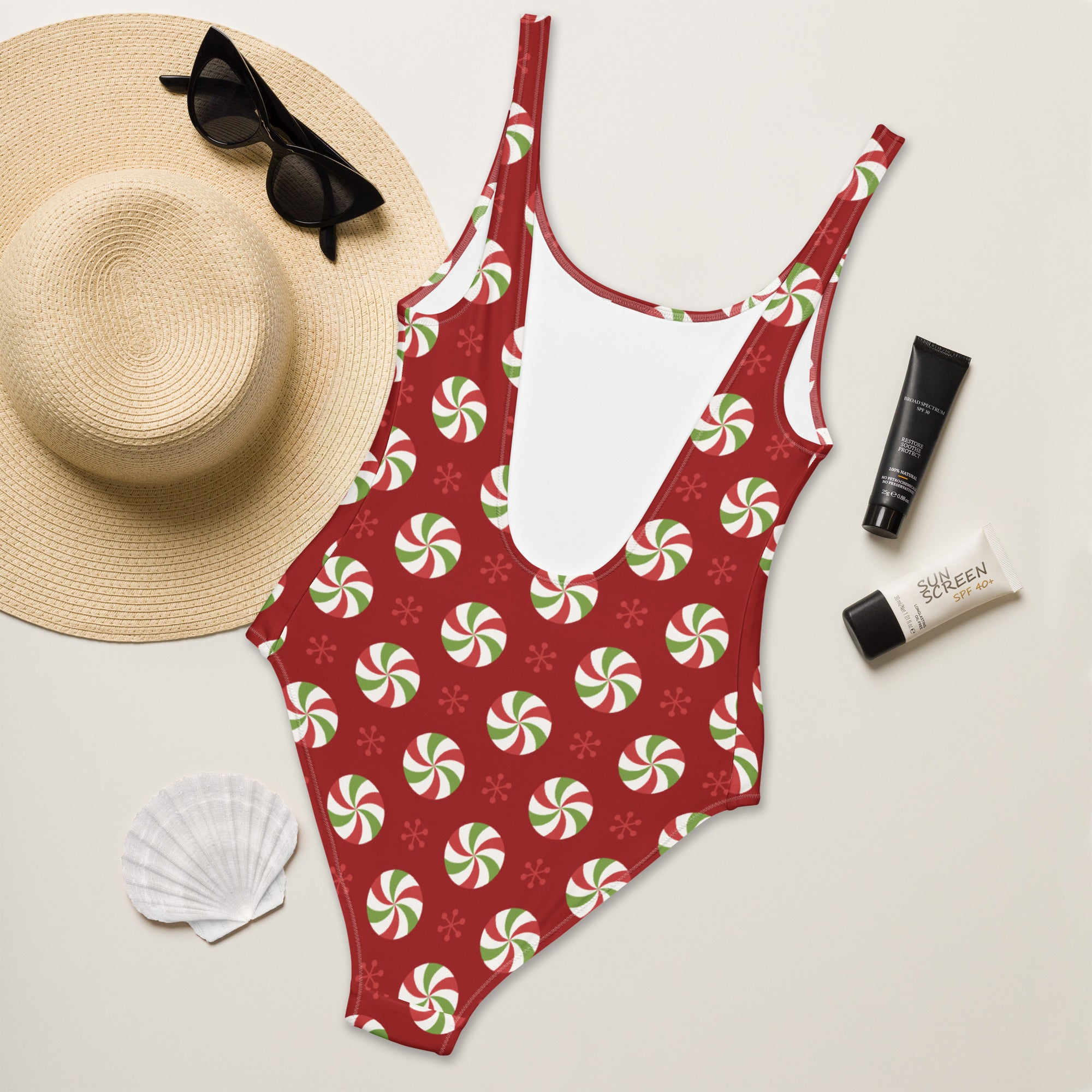 Red one-piece peppermint swirl Christmas swimsuit with buttery soft fabric and UPF 50 plus sun protection