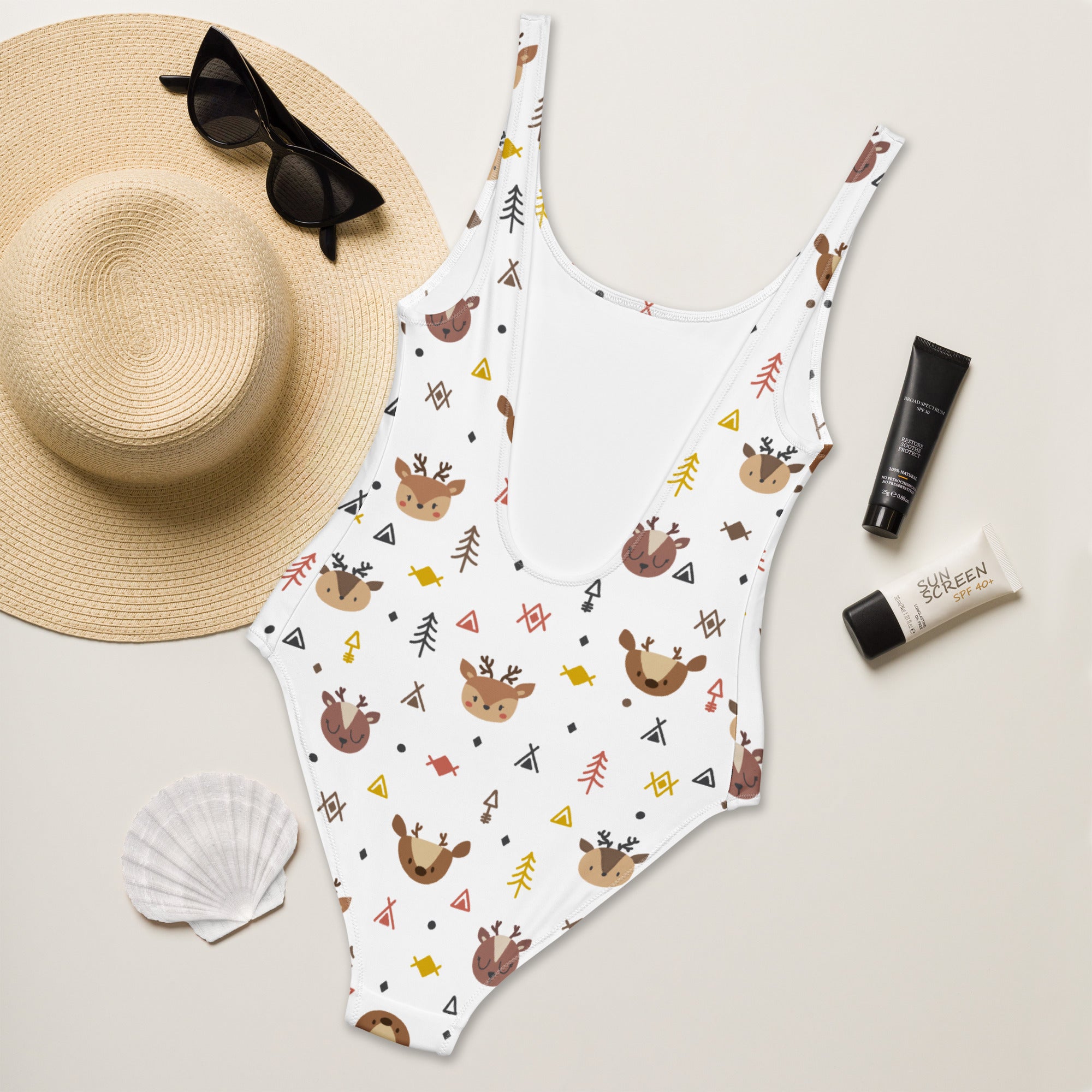 White women’s reindeer buttery soft one-piece swimsuit with brown deer pattern green trees and upf 50 plus protection