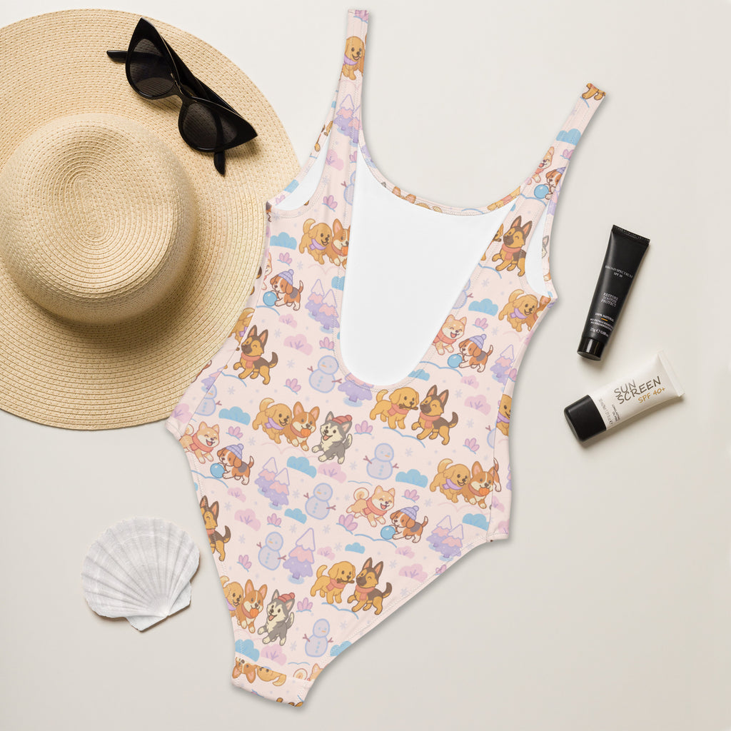 A pink one-piece buttery soft swimsuit with cartoon dogs snowmen pattern and UPF 50 plus for women