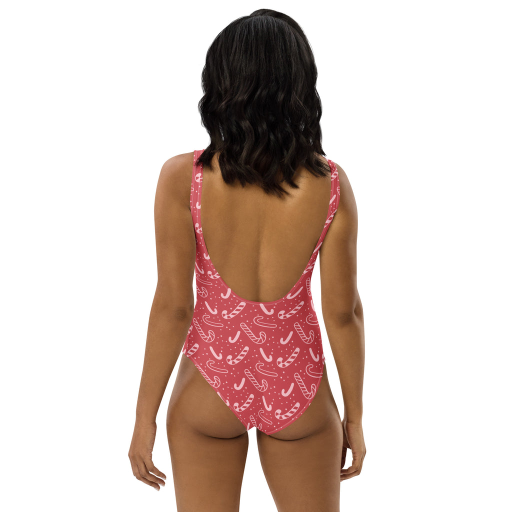 Women’s red candy cane christmas buttery soft pink one-piece swimsuit with thin straps and open back design