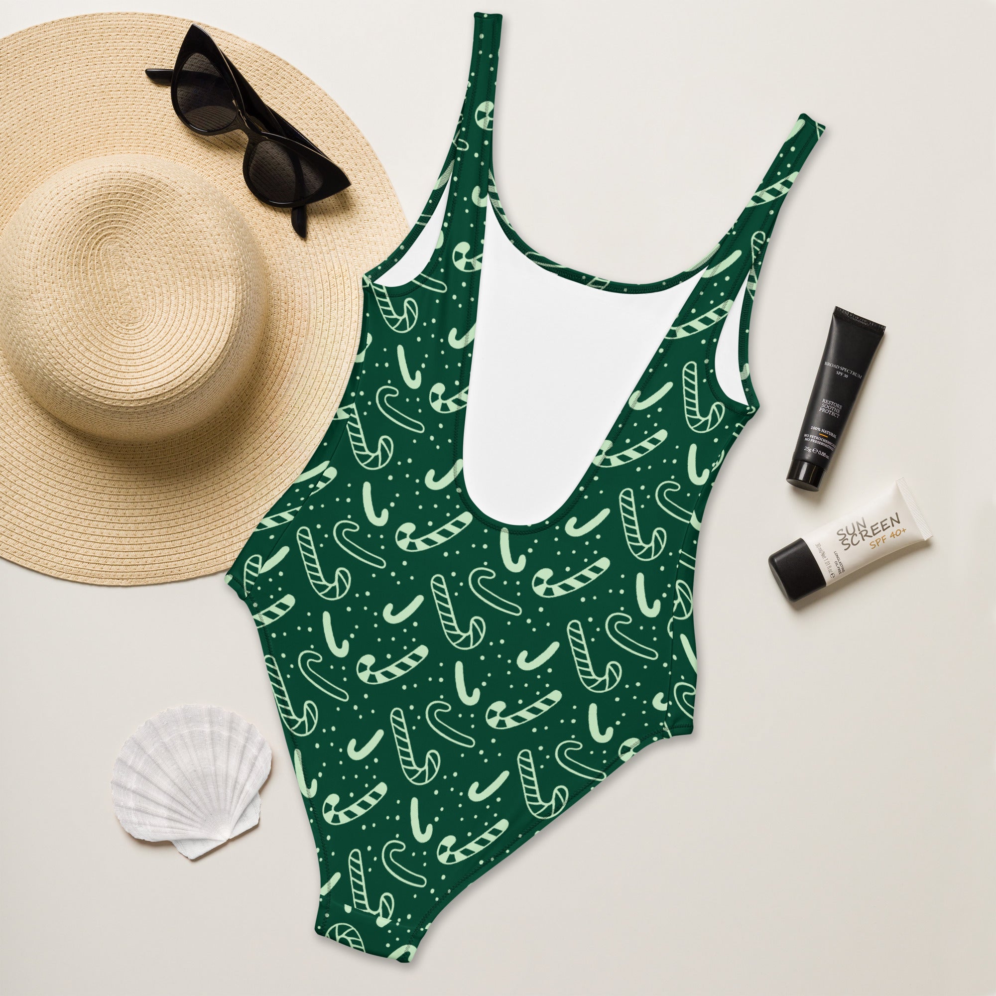 Women’s green candy cane Christmas buttery soft one-piece swimsuit with upf 50+ and deep scoop neckline