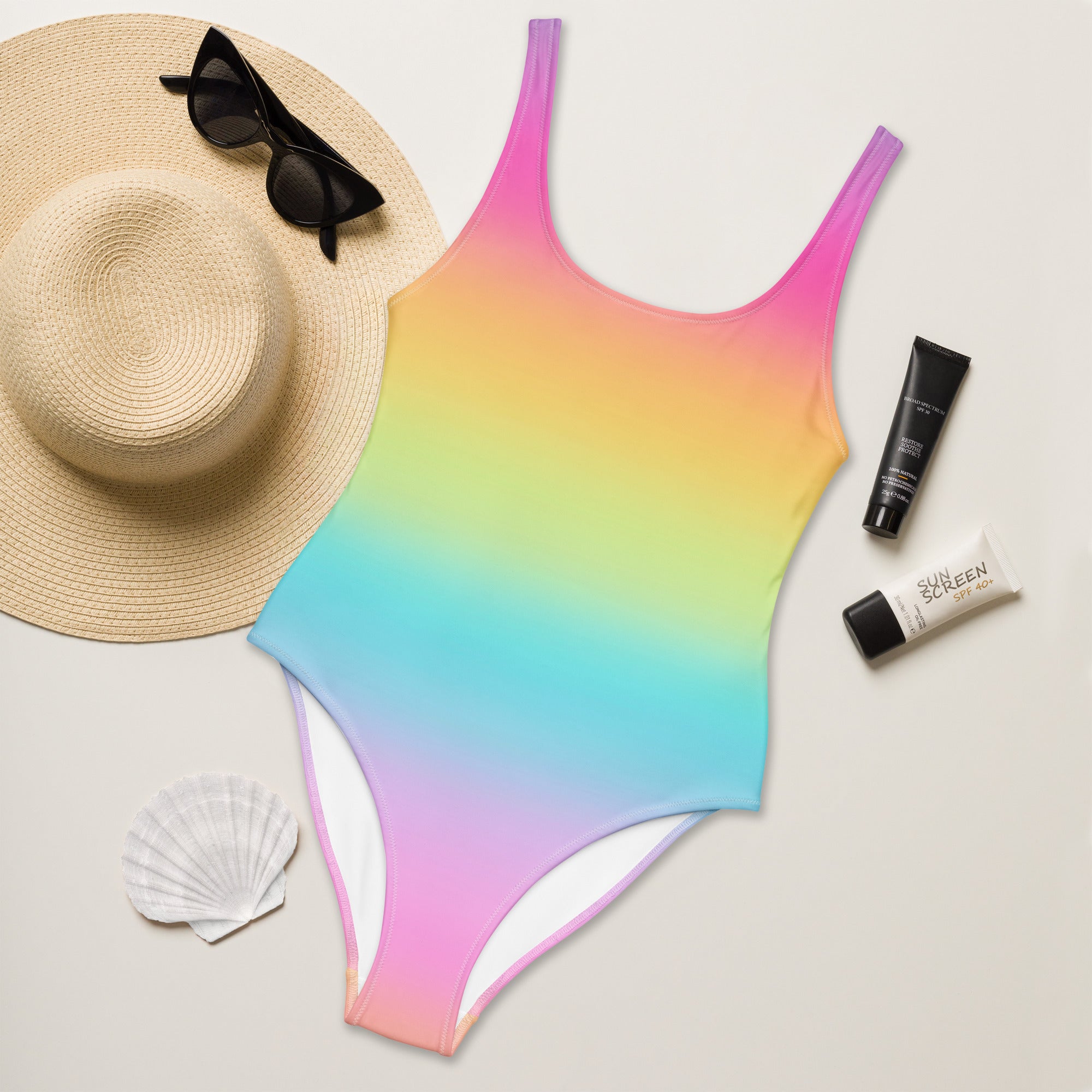 Women’s bright rainbow gradient one-piece swimsuit with thin straps white lining and buttery soft fabric with UPF 50+