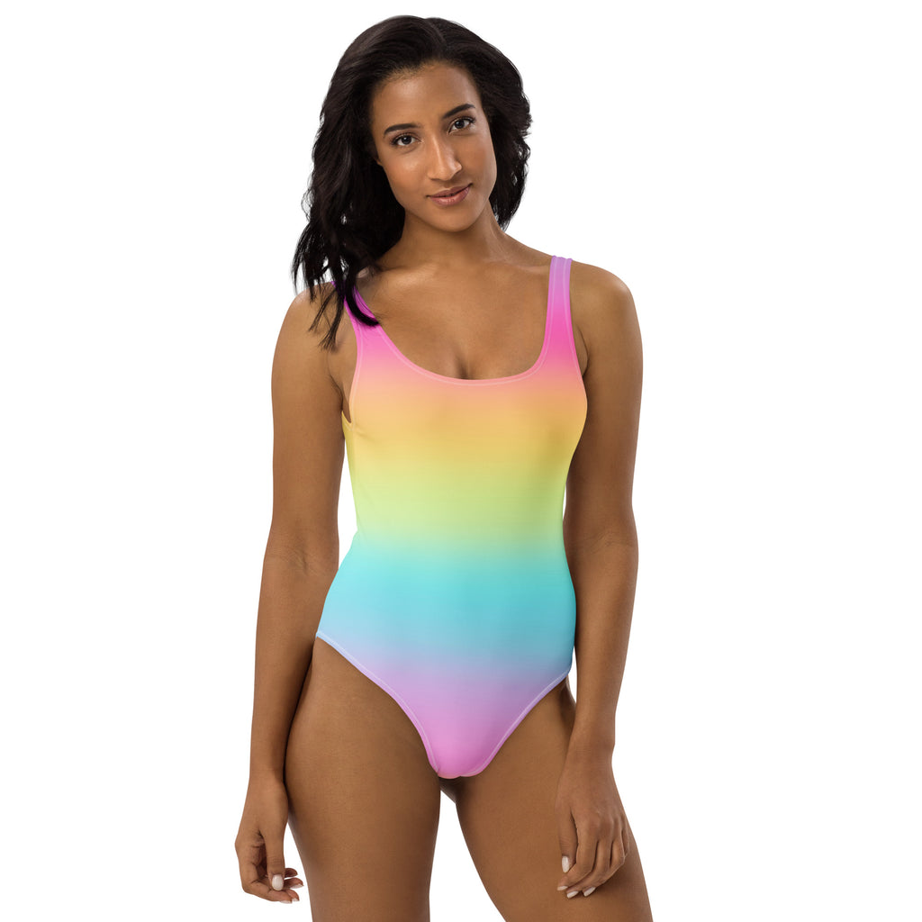 A vibrant rainbow gradient one-piece swimsuit with thin straps made of buttery soft fabric and UPF 50 plus protection