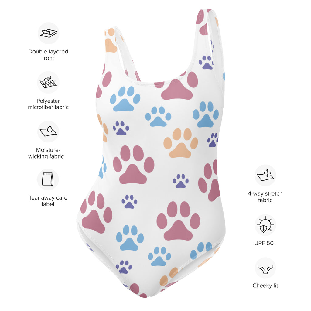 White one-piece swimsuit with colorful paw print pattern in pink blue and beige buttery soft fabric with UPF 50+