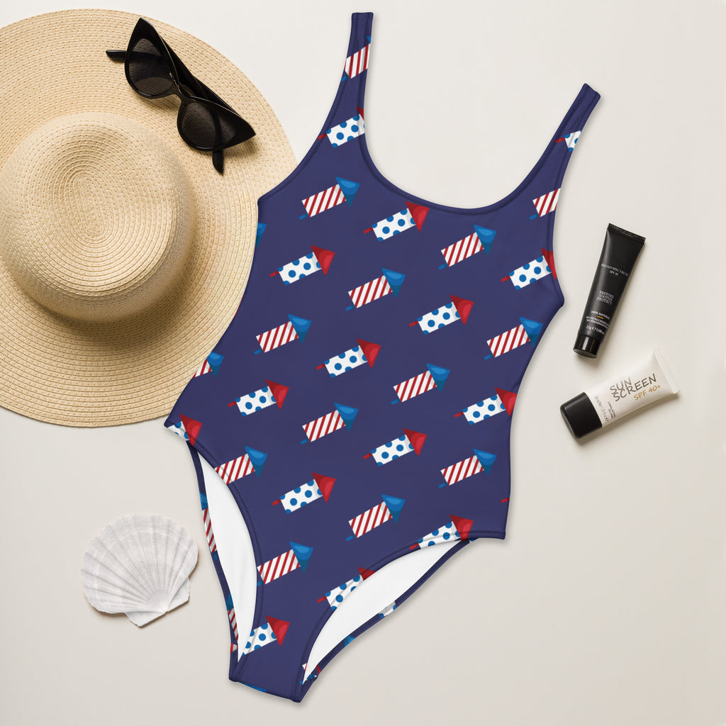 Navy blue women’s firework rockets usa buttery soft one-piece swimsuit with red white and blue fireworks and upf 50+